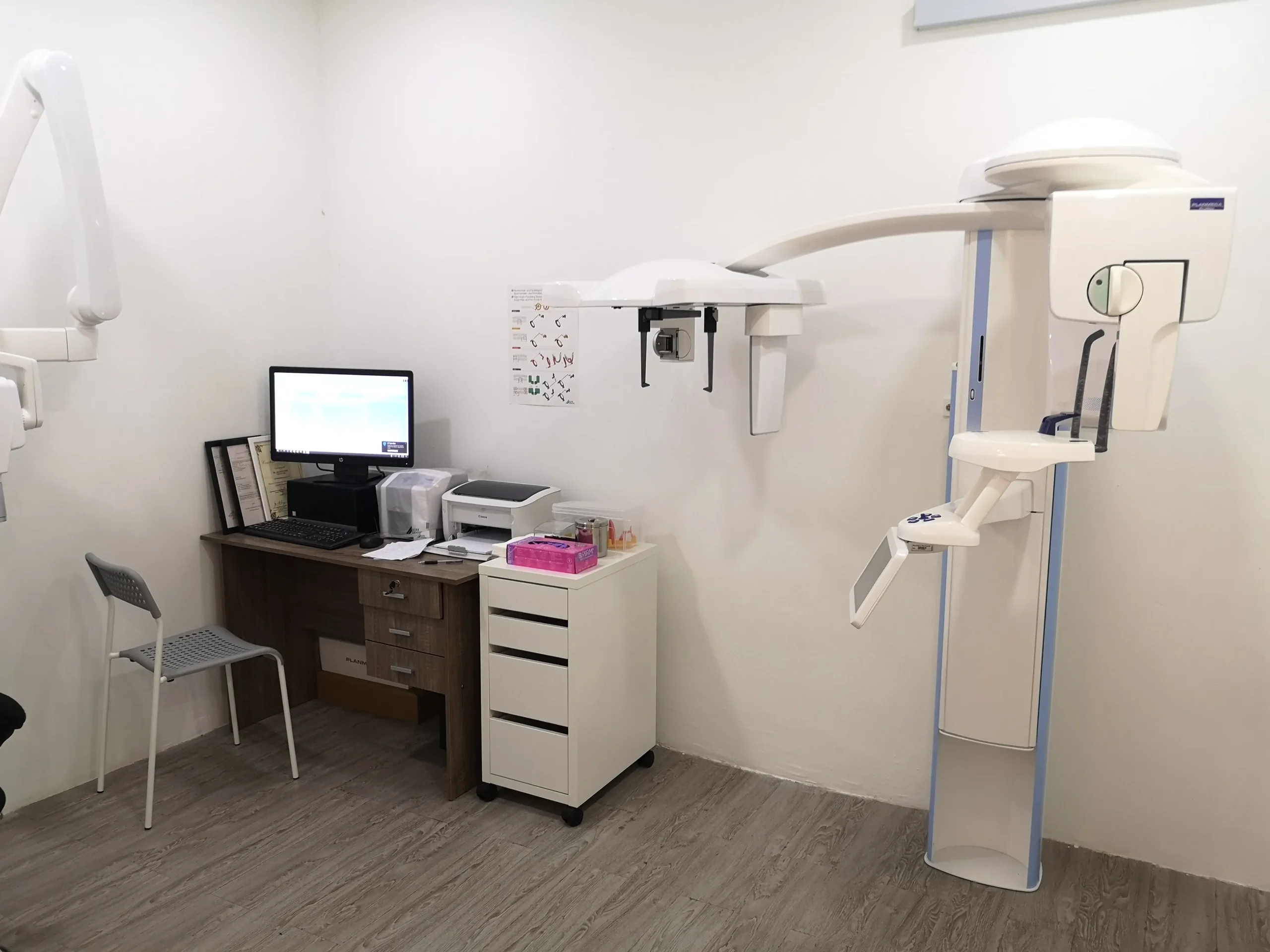 Consultation desk setup inside treatment room with modern diagnosis equipment